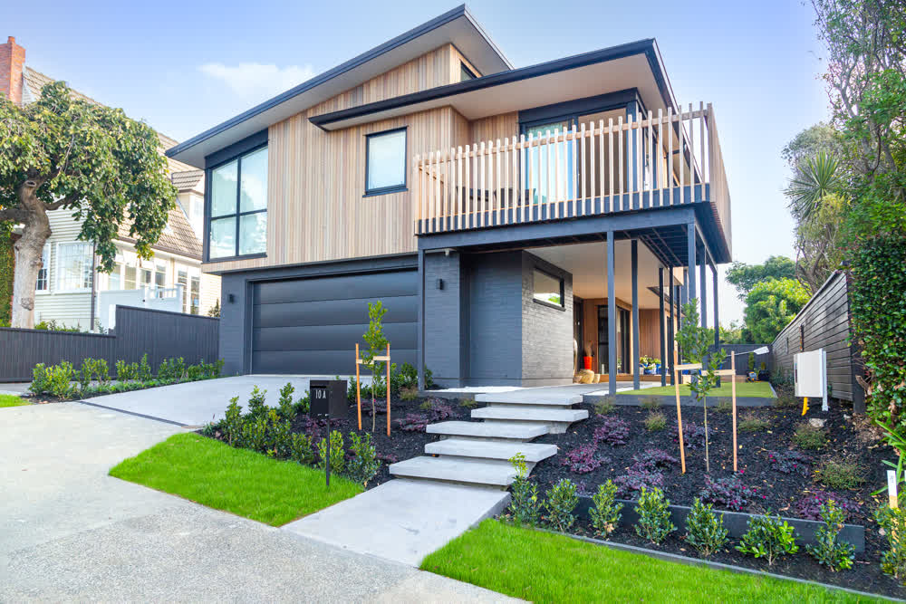 Modern front garden with pavers, lawn, and structured planting